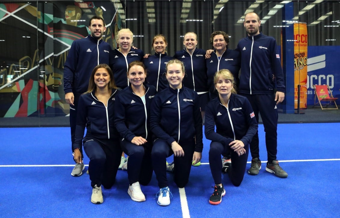 The GB womens padel team and coaches in two rows of 4 and 6. The back row are standing and the front row are on one knee.