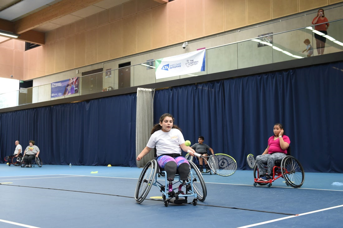 Players on court hitting at the Wheelchair Tennis Initiative day
