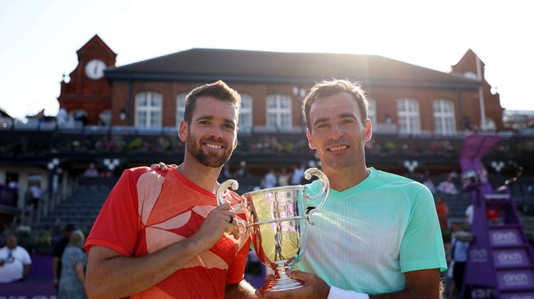 Ivan Dodig and Austin Krajicek holding their championship trophy on court at the cinch Championships