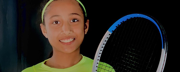 10-year-old Iraja Nagim holding a tennis racket