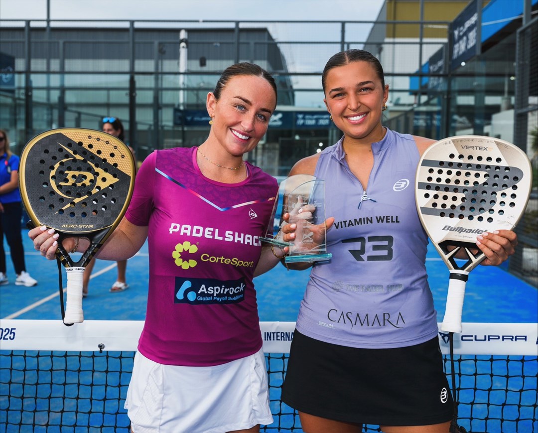 British Padel players Aimee Gibson and Catherine Rose smiling while holding their padel rackets and the FIP Silver Australian Padel Open trophy