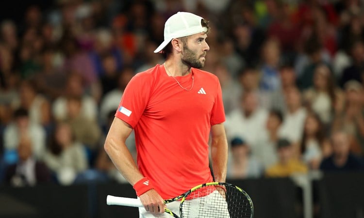 British tennis player Jacob Fearnley holding his racket and looking ahead during his first round match against Nick Kyrgios at the 2025 Australian Open