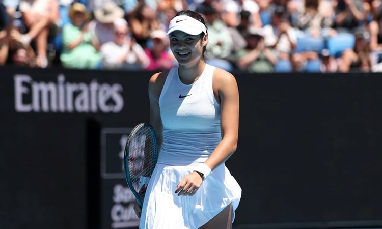 Emma Raducanu smiles on court during her second round clash with Amanda Anisimova at the Australian Open