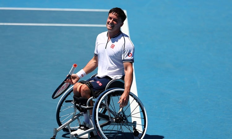 Gordon Reid sat in his wheelchair on court while smiling at the Australian Open