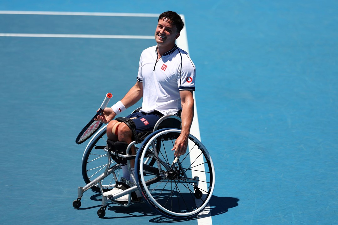 Gordon Reid sat in his wheelchair on court while smiling at the Australian Open