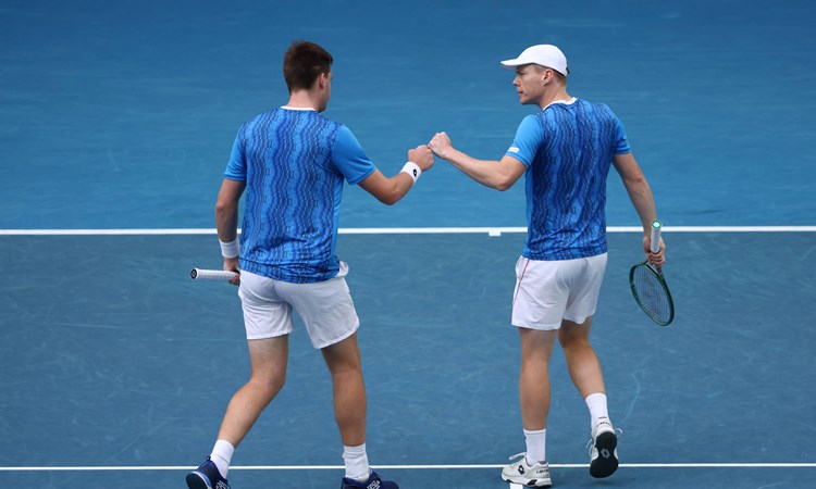 Henry Patten and Harri Heliovaara fist bumping during the Australian Open semi-final