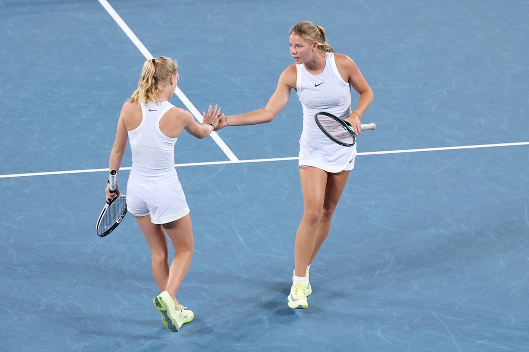 Hannah Klugman and Emerson Jones high five during the Australian Open semi-final