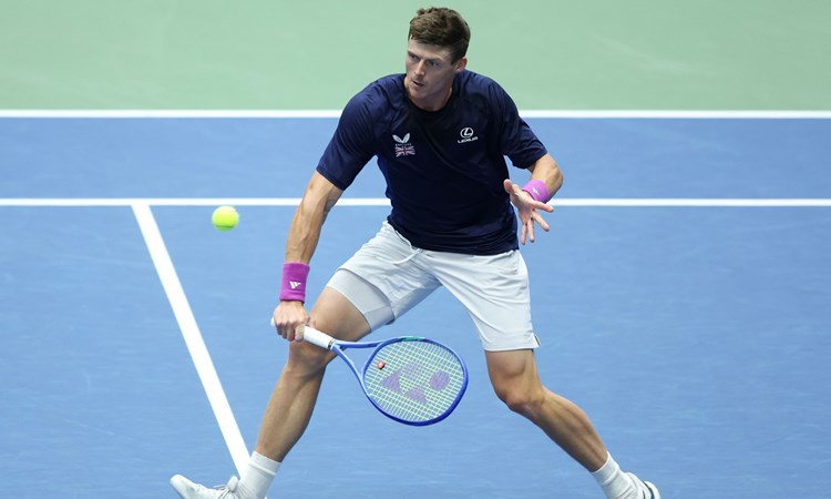 Billy Harris crouching down to hit a backhand at the Davis Cup Qualifiers