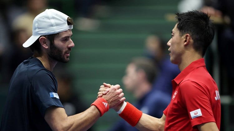 Jacob Fearnley and Kei Nishikori shake hands at the Davis Cup