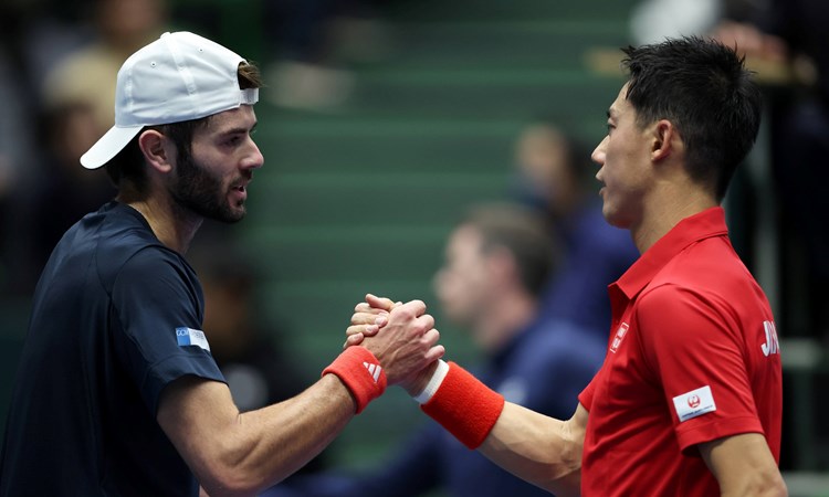 Jacob Fearnley and Kei Nishikori shake hands at the Davis Cup