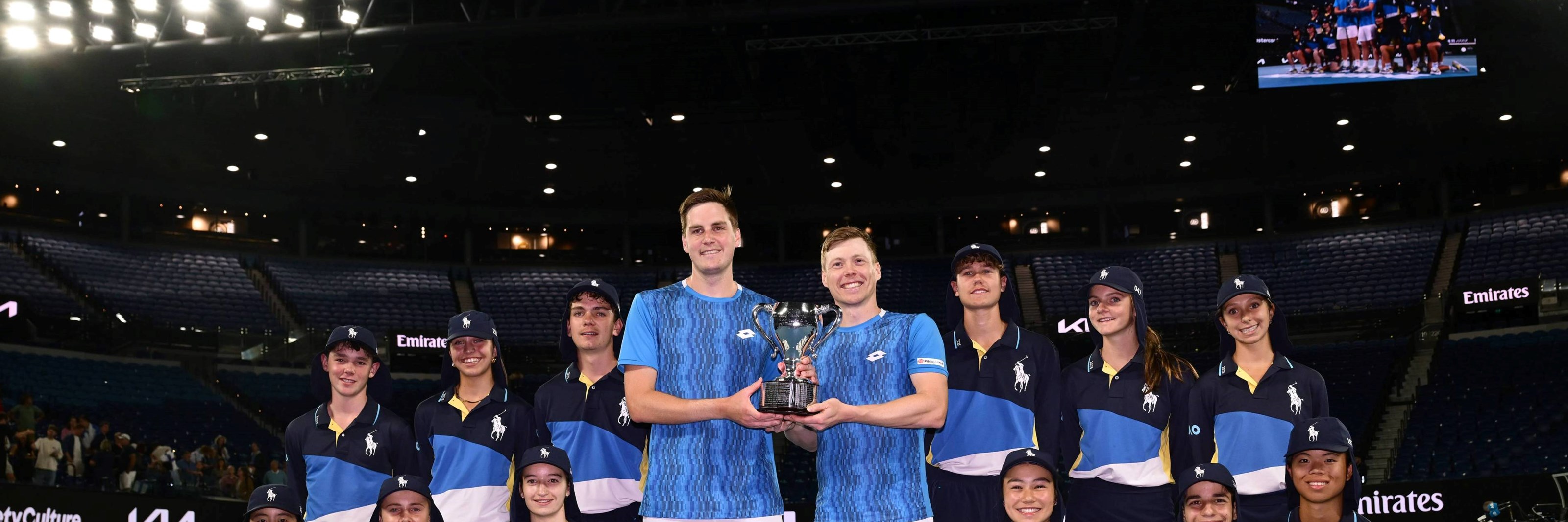 Hnery Patten and Harri Heliovaara holding the 2025 Australian Open men's doubles trophy