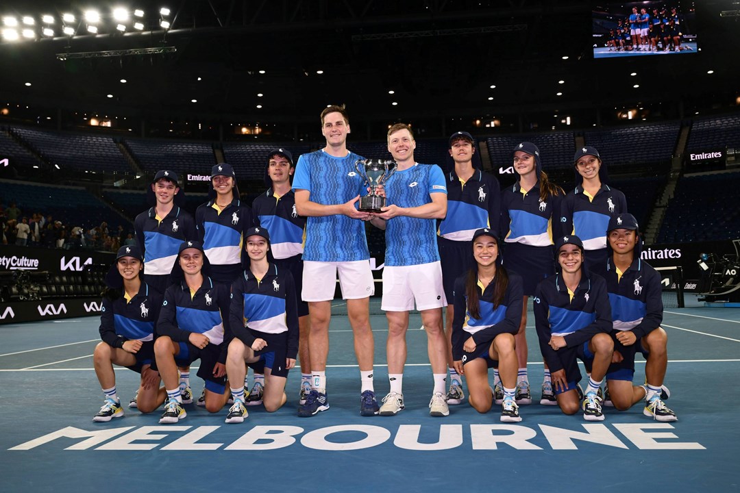 Hnery Patten and Harri Heliovaara holding the 2025 Australian Open men's doubles trophy