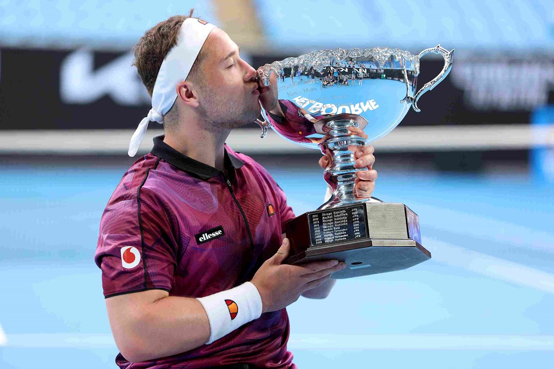 Alfie Hewett kisses the wheelchair singles Australian Open trophy