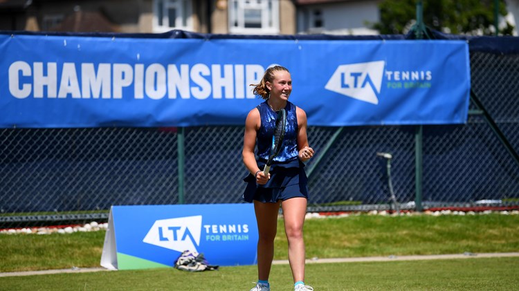 Player on court with blue LTA County Championships banner in background