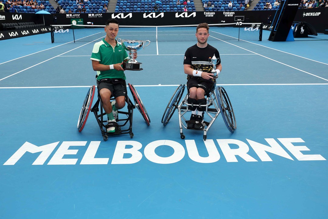 Tokito Oda and Alfie Hewett sat holding their trophies on court at the Australian Open