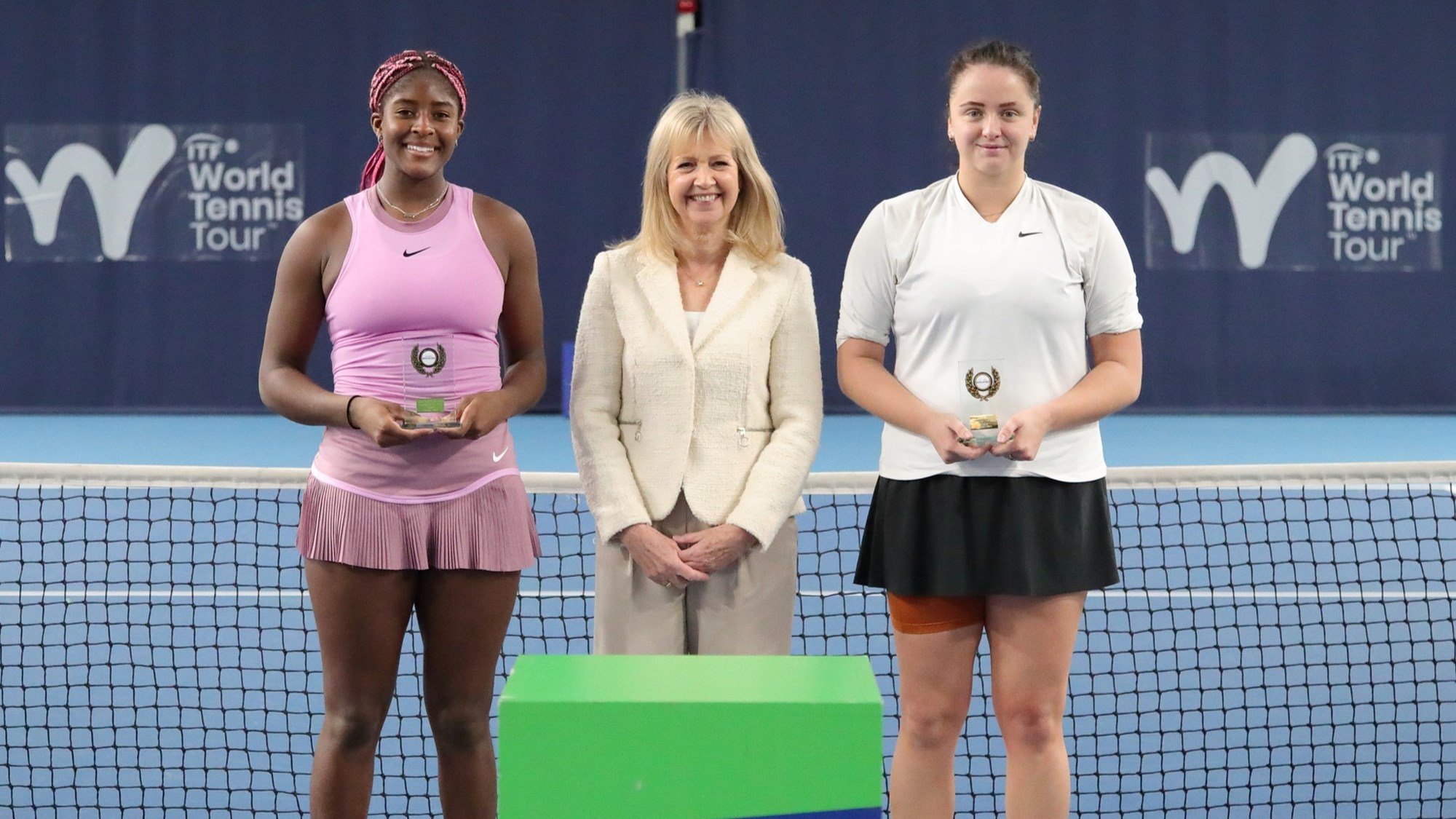 Clervie Ngounoue and runner-up Viktoria Hrunkova holding their Lexus British Pro Series Birmingham trophies on court 