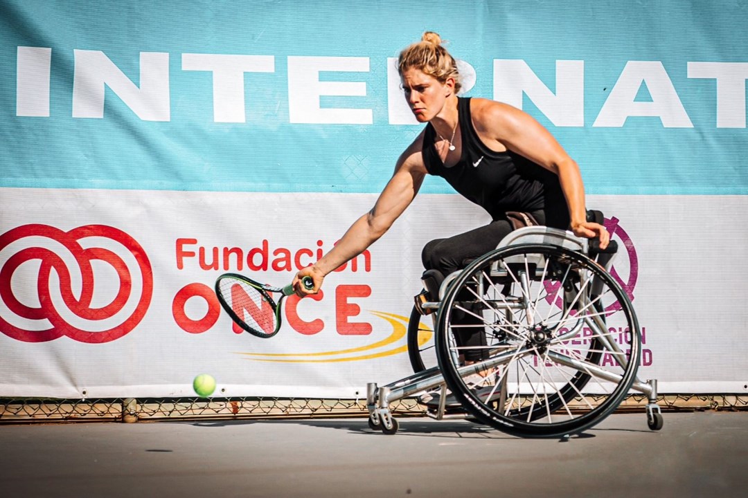 Robyn Love in wheelchair tennis action hitting a forehand