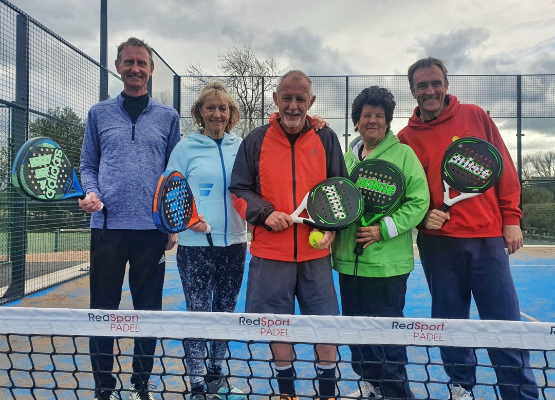 A group of individuals posing with padel rackets to mark the opening of Church Broughton's first ever tennis padel court