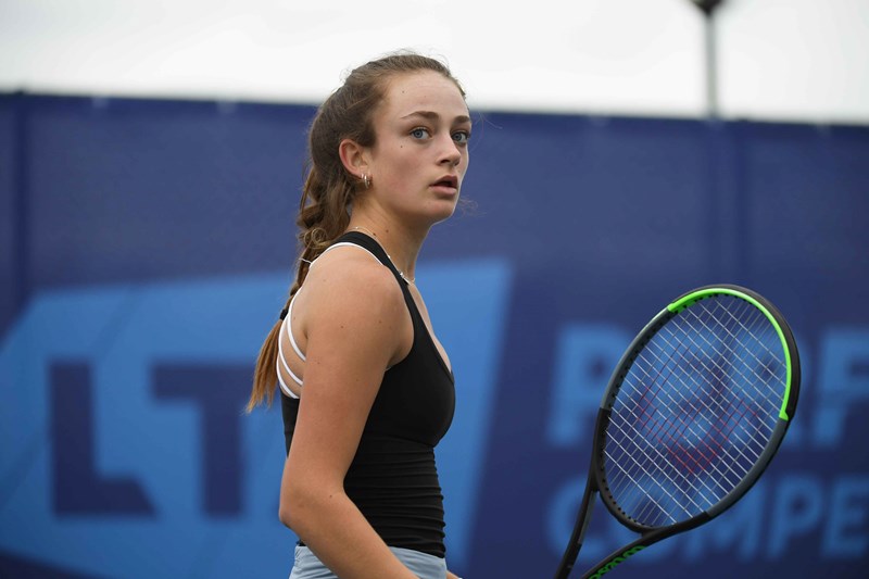 Isabelle Lacy holding a tennis racket on court