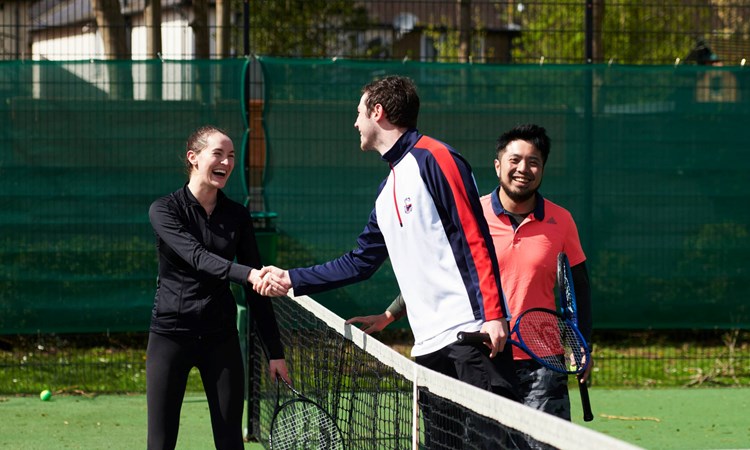 Local Tennis Leagues players shaking hands at the net