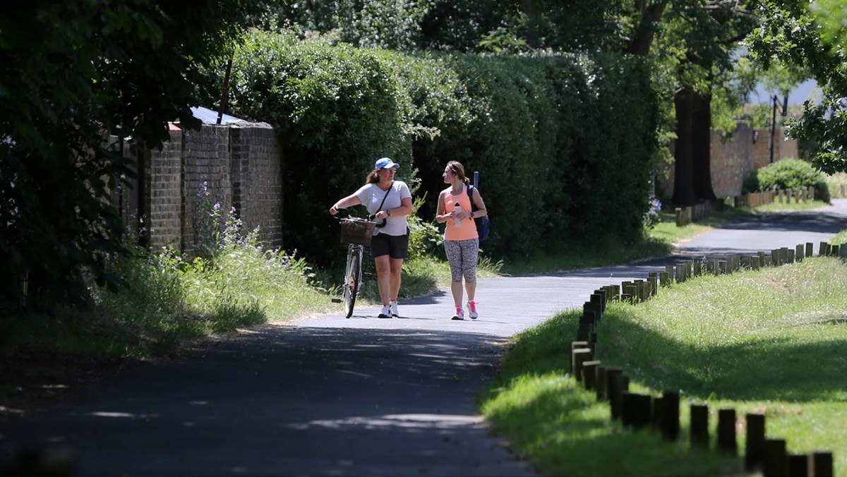 Two-female-tennis-players-with-a-bike.jpg