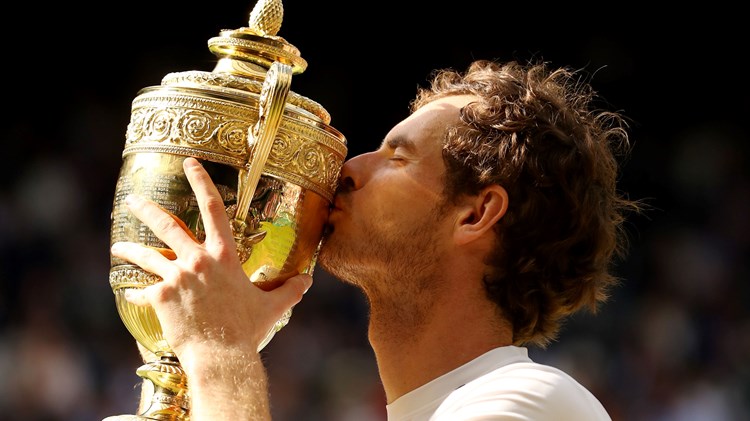 Andy Murray kisses the trophy after being crowned Wimbledon champion for the second time in his career