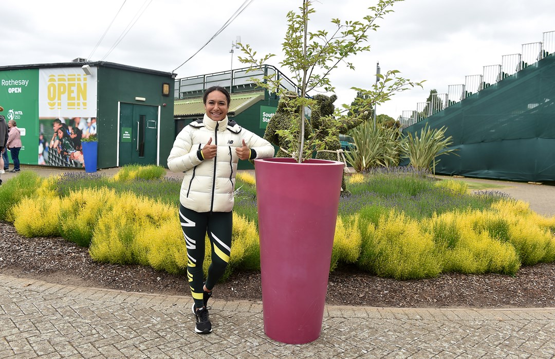 Heather Watson poses next to the cherry blossom tree she helped the LTA plant at Nottingham Tennis Centre to mark the Platinum Jubilee