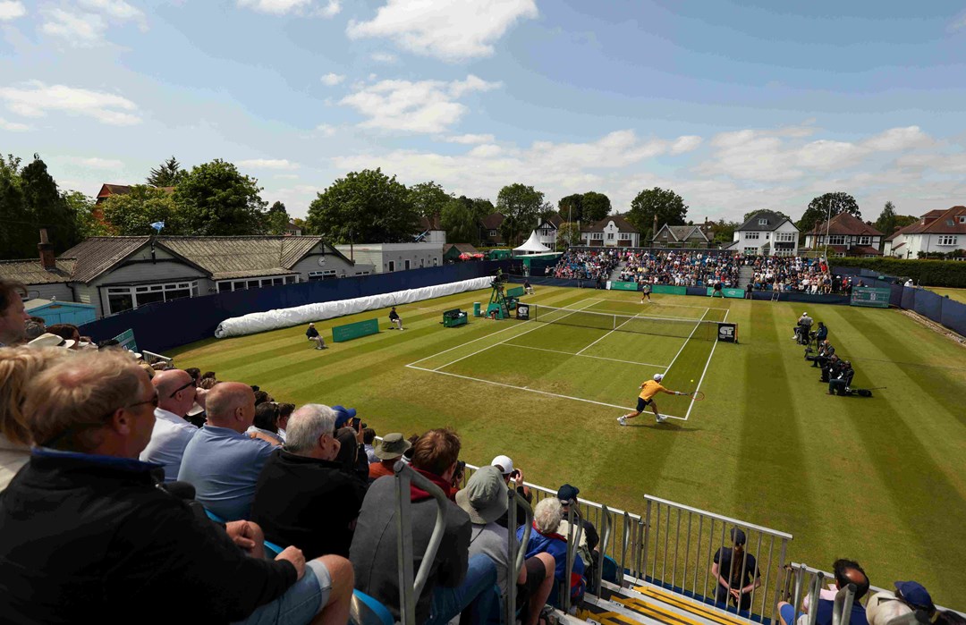 Centre Court at the Lexus Surbiton Trophy with a crowd watching on as two tennis players play