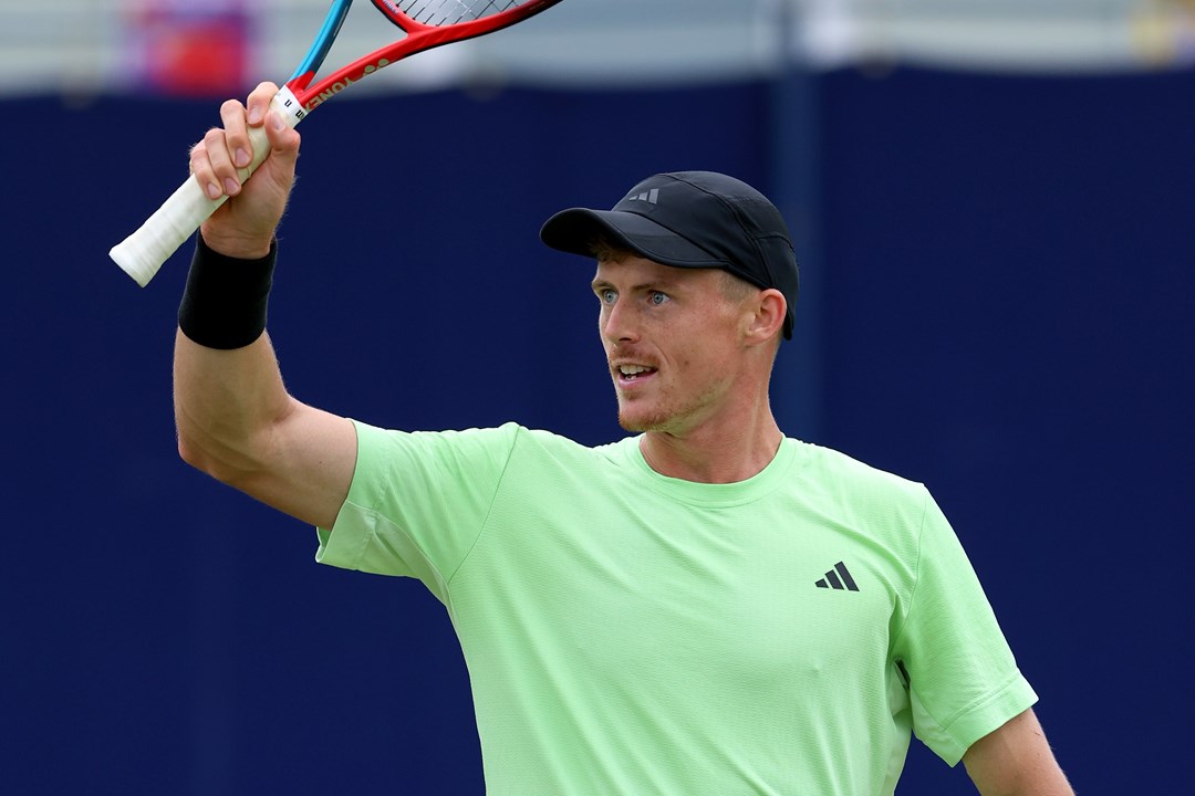 Billy Harris raises a racket in celebration at the Lexus Surbiton Trophy