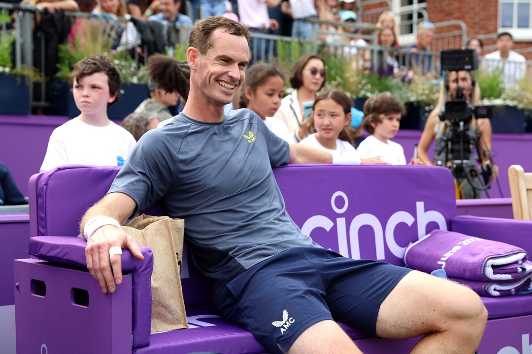 Andy  Murray sitting in a cinch branded chair on court at the cinch Championships while smiling