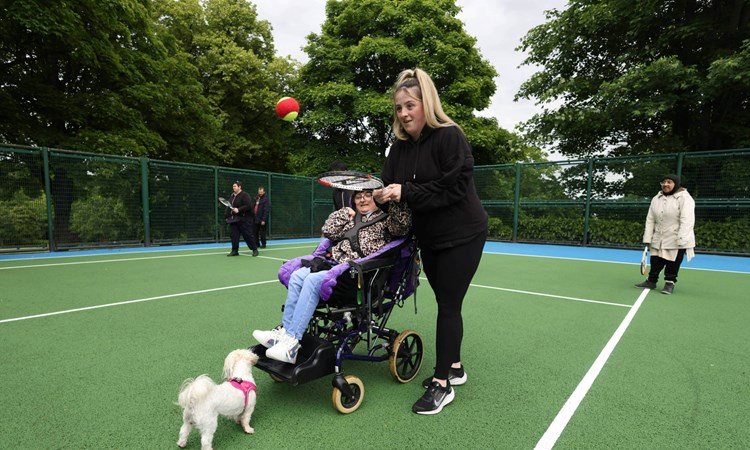 A player giving tennis a try at a disability session at Lister Park tennis courts