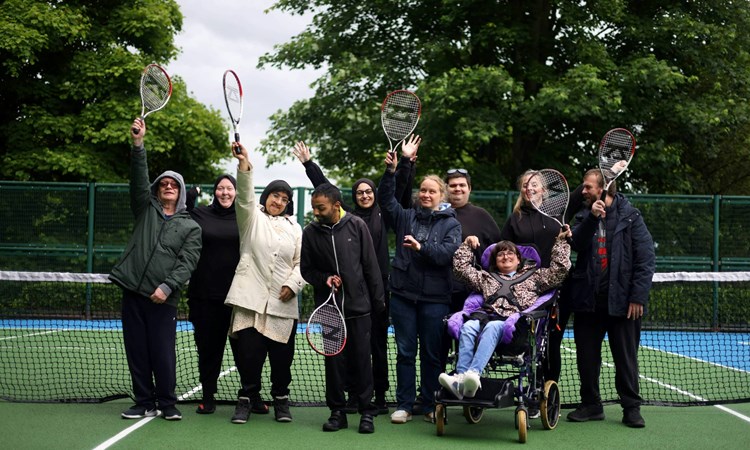 Players on court raising a racket at a disability tennis session and Lister Park courts