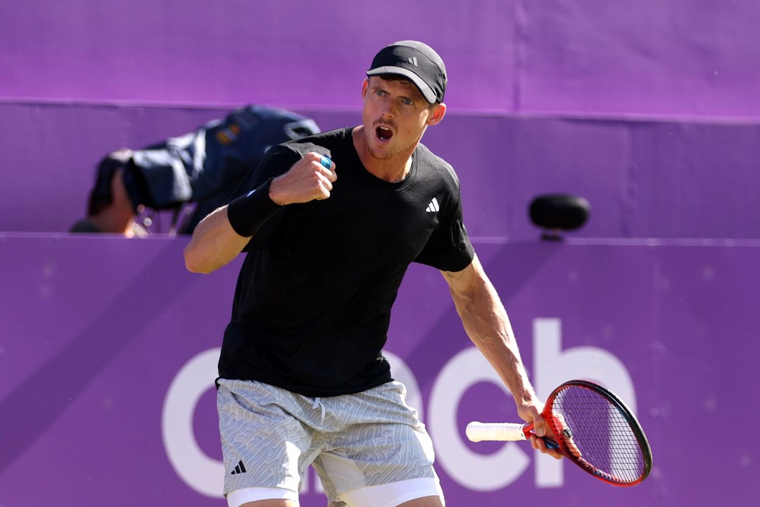 Billy Harris clenching his fist and cheering on court with cinch championships branding behind him