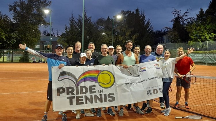 Geordie Grand Slammers members united on the clay holding a Pride in Tennis banner.
