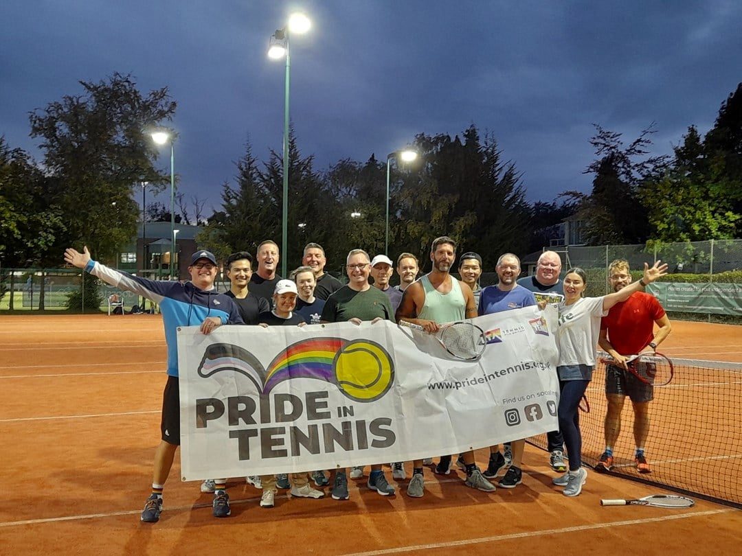 Geordie Grand Slammers members united on the clay holding a Pride in Tennis banner.