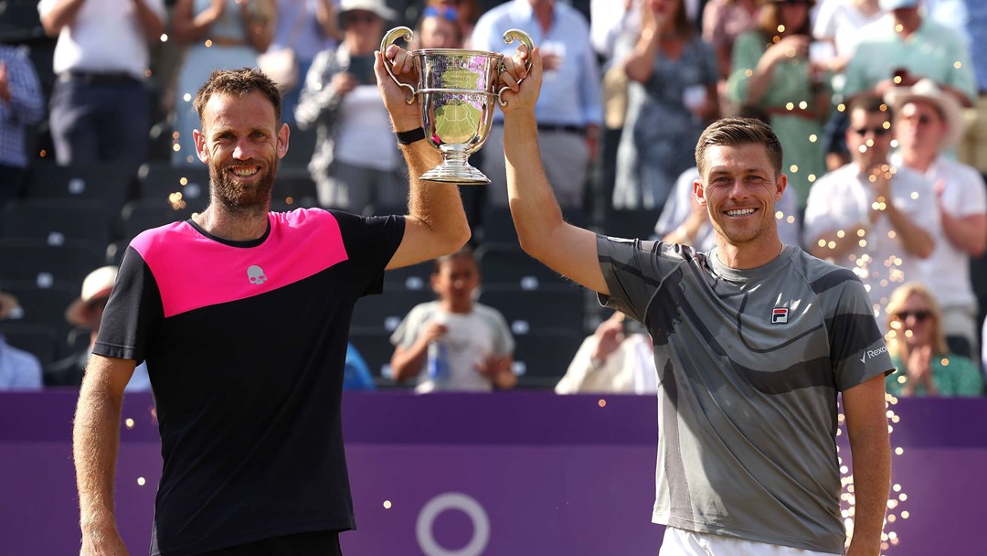 Michael Venus and Neal Skupski lifting their mens doubles title in the air at the cinch Championships