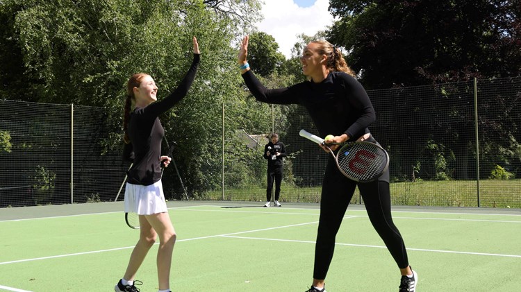 GB doubles player Freya Christie high fives a park tennis player