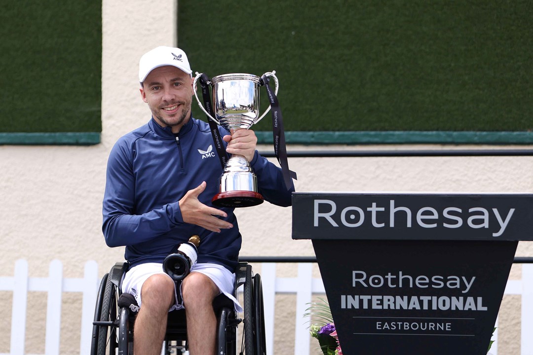 Wheelchair player Andy Lapthorne holding his trophy on court at the Rothesay International Eastbourne