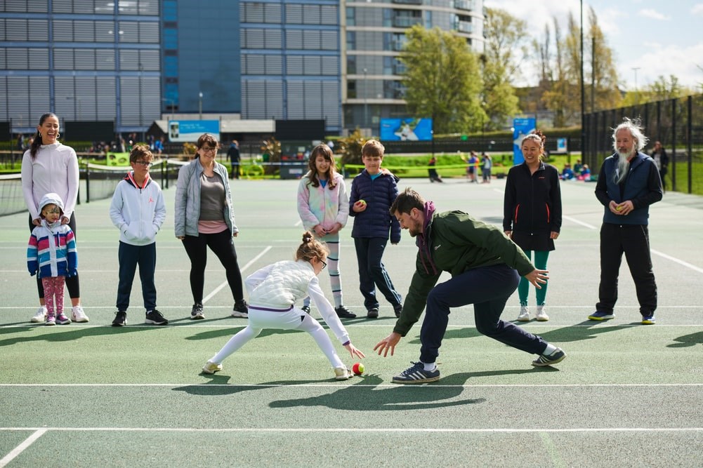 People of all ages taking part in a Free Park Tennis session