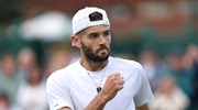 Jacob Fearnley clenching his fist in celebration on court at Wimbledon