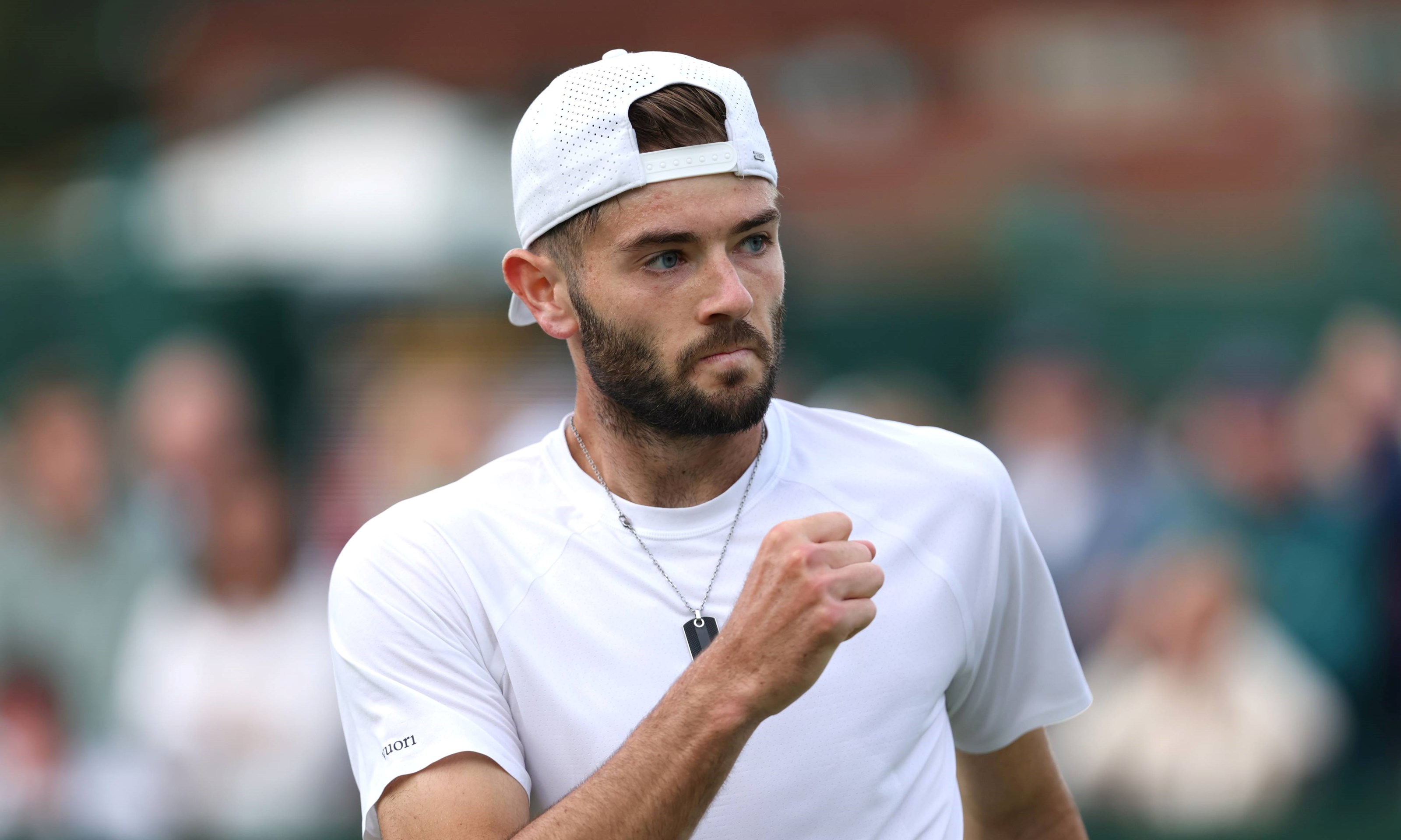 Jacob Fearnley clenching his fist in celebration on court at Wimbledon