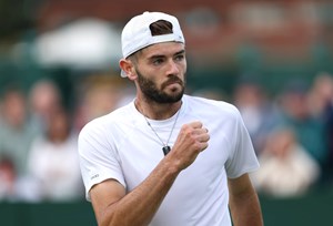 Jacob Fearnley clenching his fist in celebration on court at Wimbledon