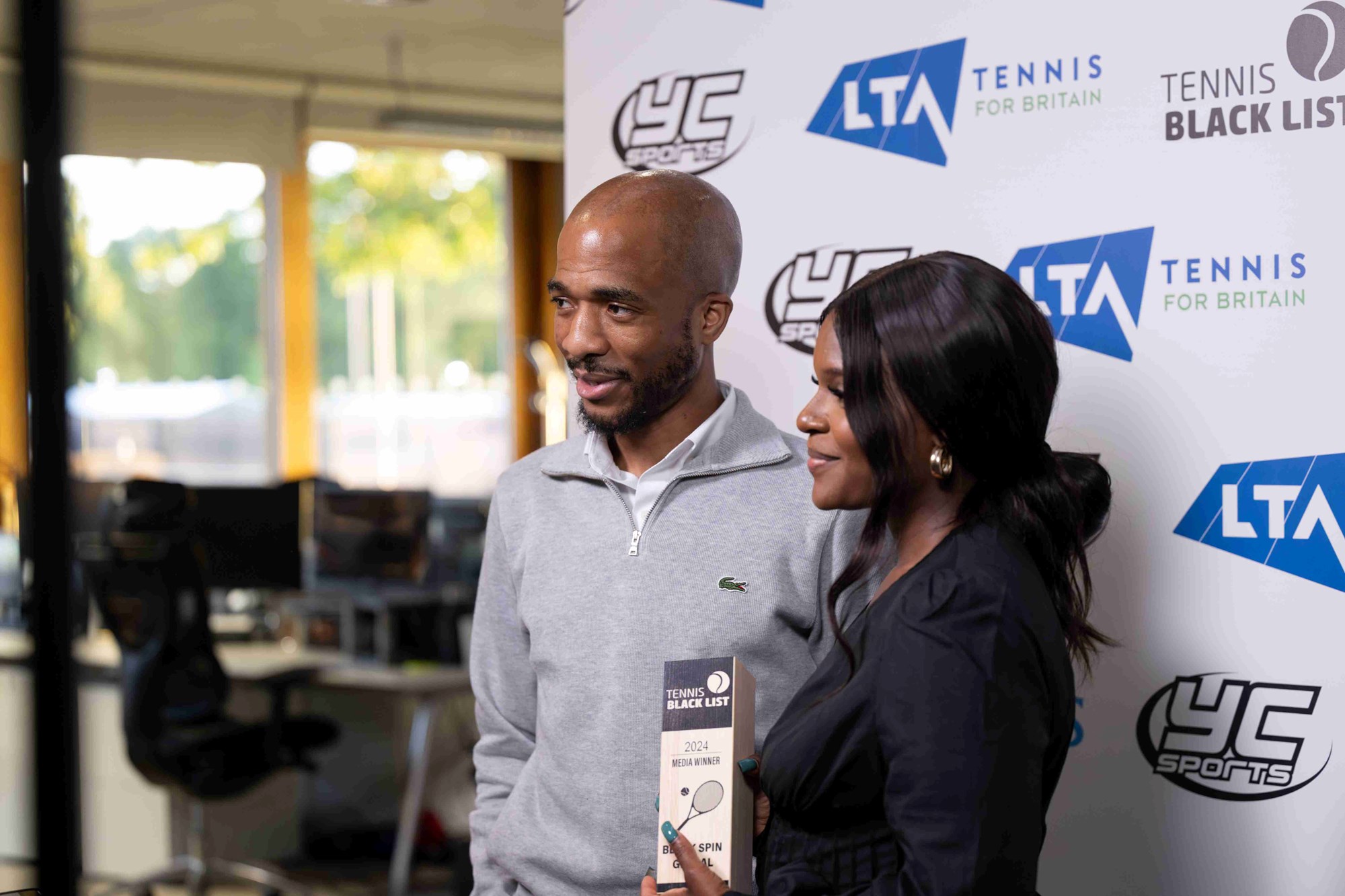 Hosts of the Black Spin Podcast holding their award while smiling at the Tennis Black List Awards