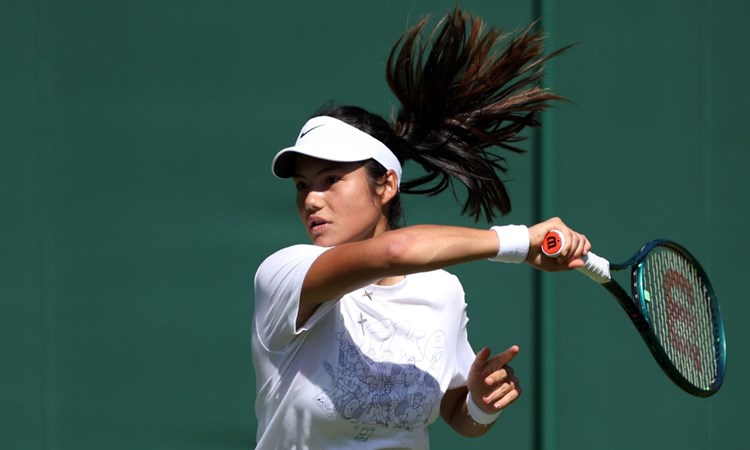 Emma Raducanu hitting a forehand on court at Wimbledon