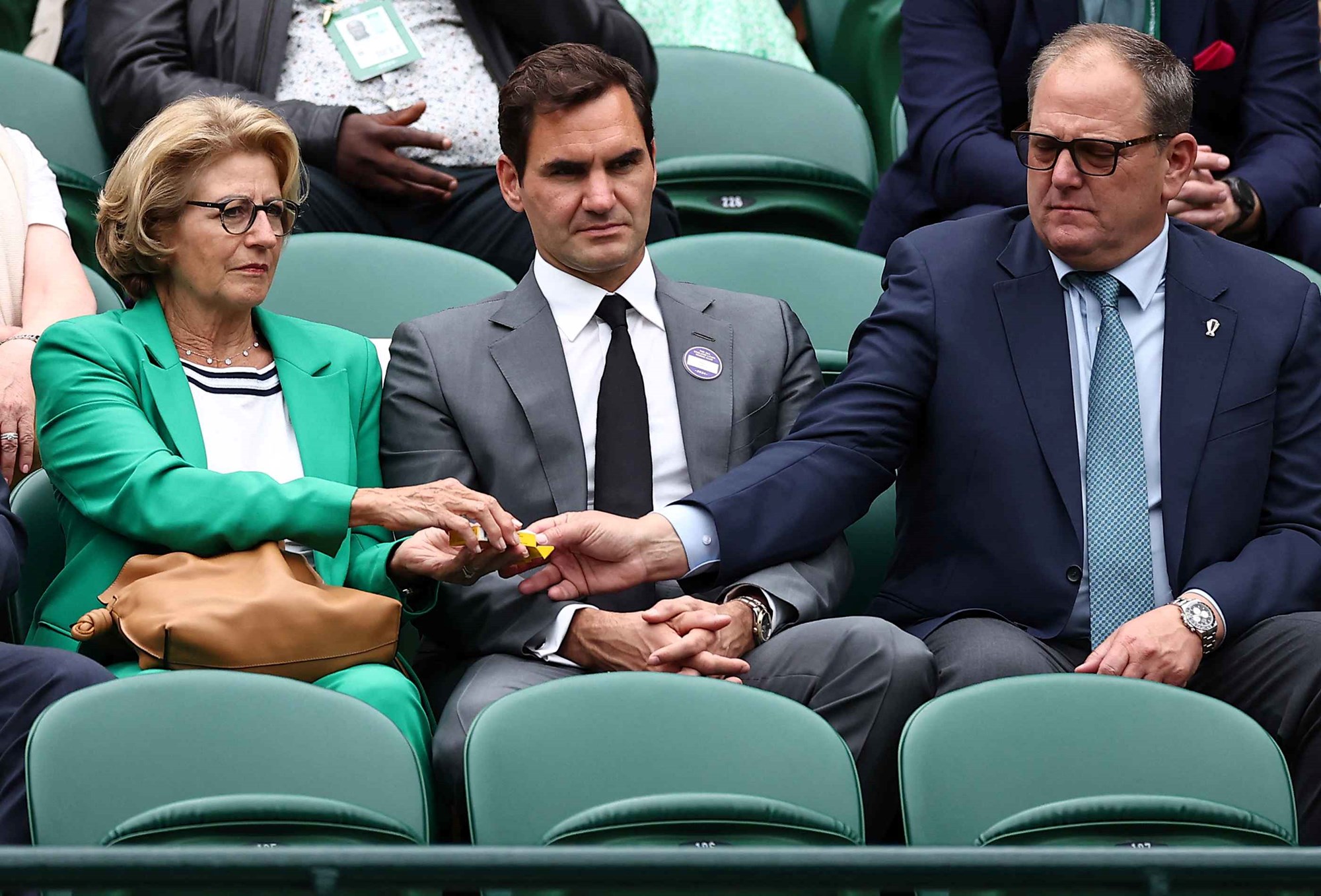 Roger Federer sat in between his mum and dad on court at Wimbledon