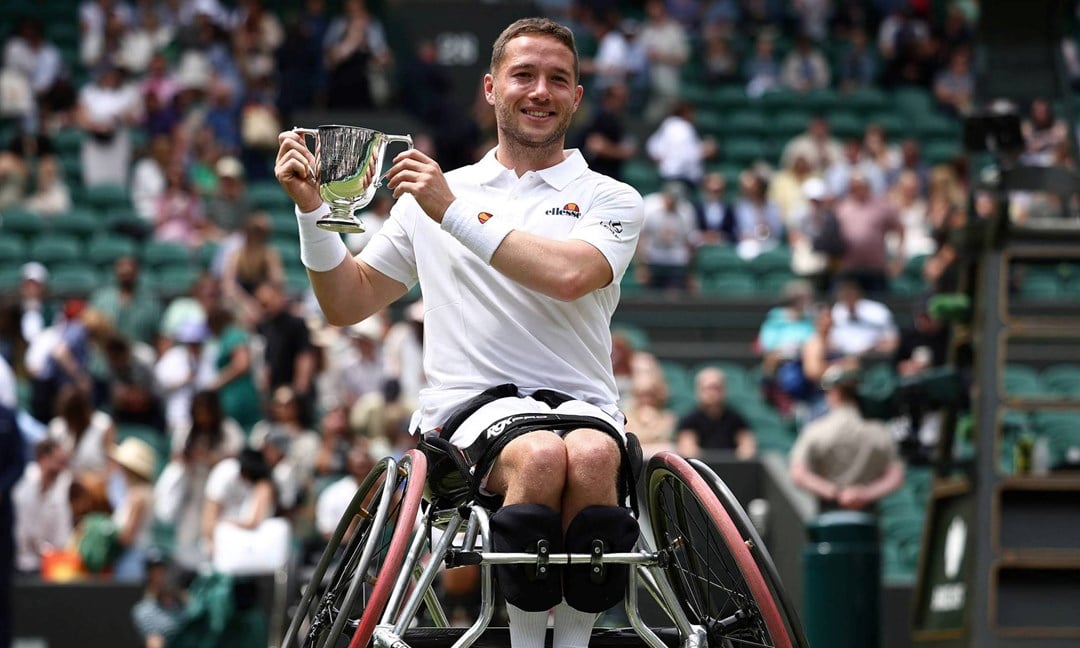 Alfie Hewett holding the men's wheelchair singles title at Wimbledon