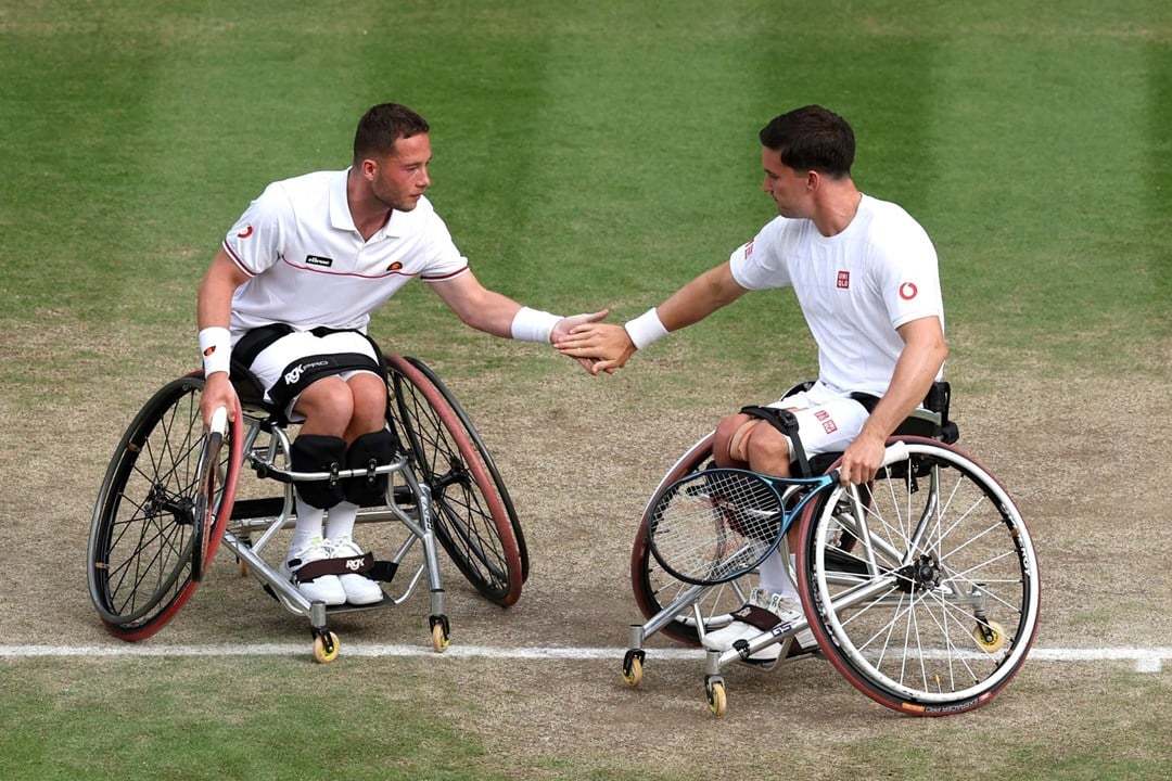 Alfie Hewett and Gordon Reid high five during doubles action at Wimbledon