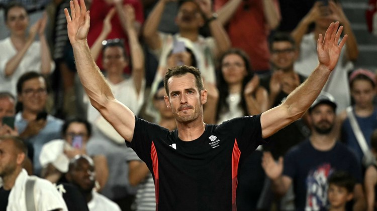 Andy Murray waves to the crowd one final time after his final match at the Olympics