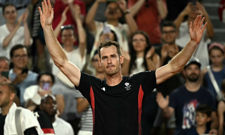 Andy Murray waves to the crowd one final time after his final match at the Olympics