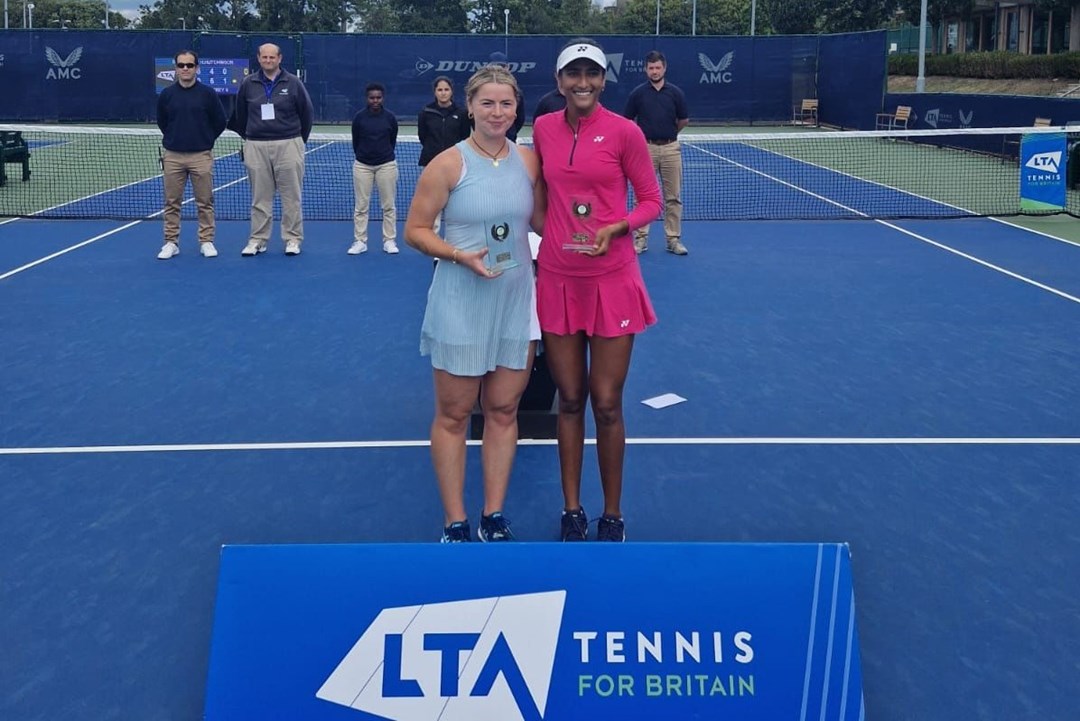 Sarah Beth Grey stood next to Rutuja Bhosale on court holding their winners trophies